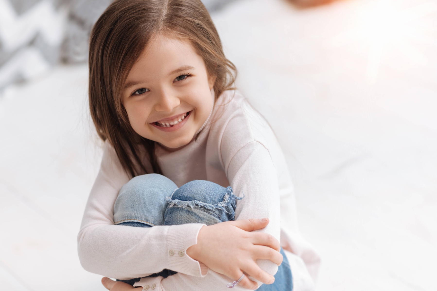 Young girl smiling holding her knees, albany wa